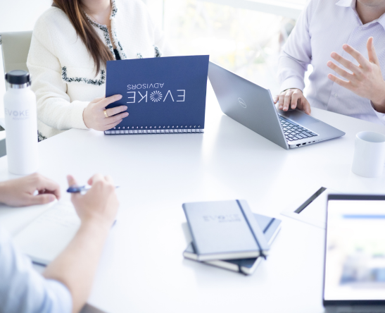 Three co-workers collaborating in conference room